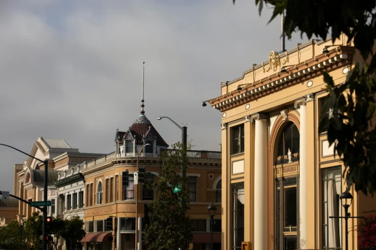 Ornate historic buildings on a downtown Salinas street corner, featuring a turret, arched windows, and classical columns.