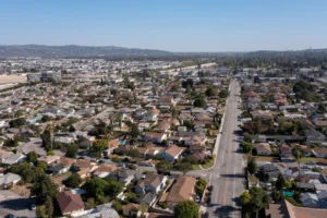 Aerial view of a residential neighborhood in Los Angeles, California, showcasing houses, streets, and greenery.