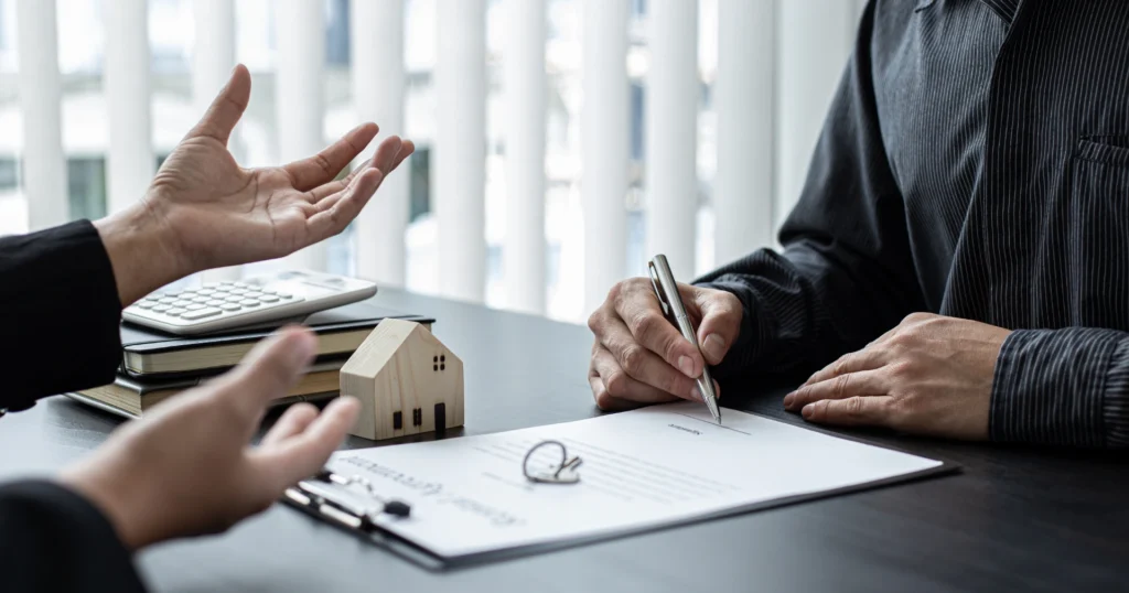 A real estate agent guides a client through a modern home, highlighting features and discussing potential purchase options.